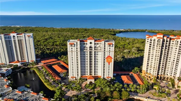 an aerial view of residential building and ocean view