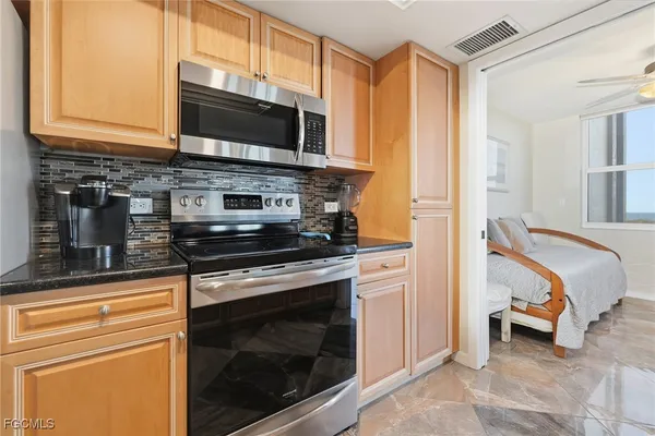 a kitchen with granite countertop a sink and cabinets