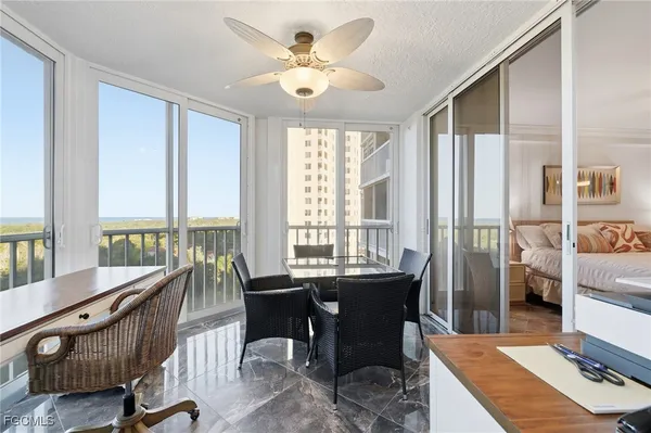 a view of a dining room with furniture large windows and wooden floor