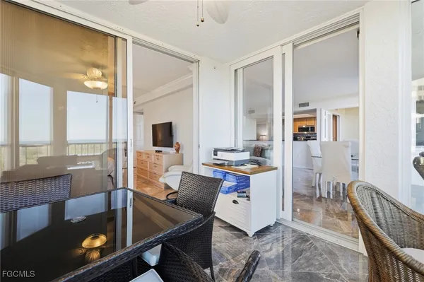 a spacious bedroom with a bed and a chandelier