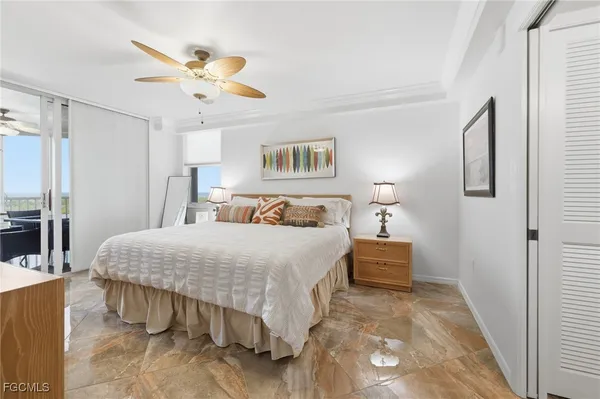 a bedroom with a bed and a large mirror