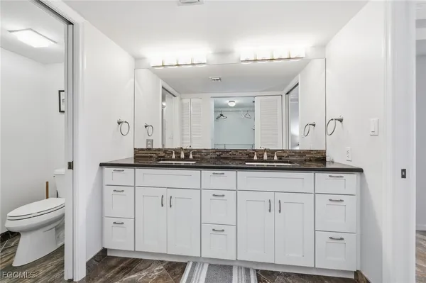 a kitchen with stove and white cabinets