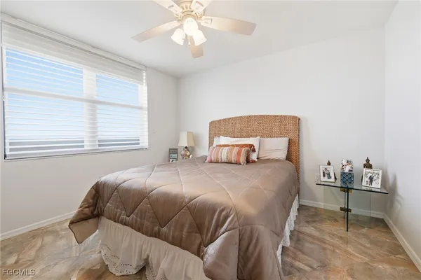 a room with a bed and a view of kitchen
