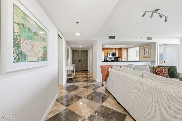 a large kitchen with stainless steel appliances a sink and a refrigerator