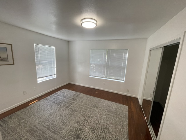 4611 Glissman Road Austin, TX 78702 - Photo 9 of 11 Hardwood floors and generous windows create a light-filled and inviting sleeping space.