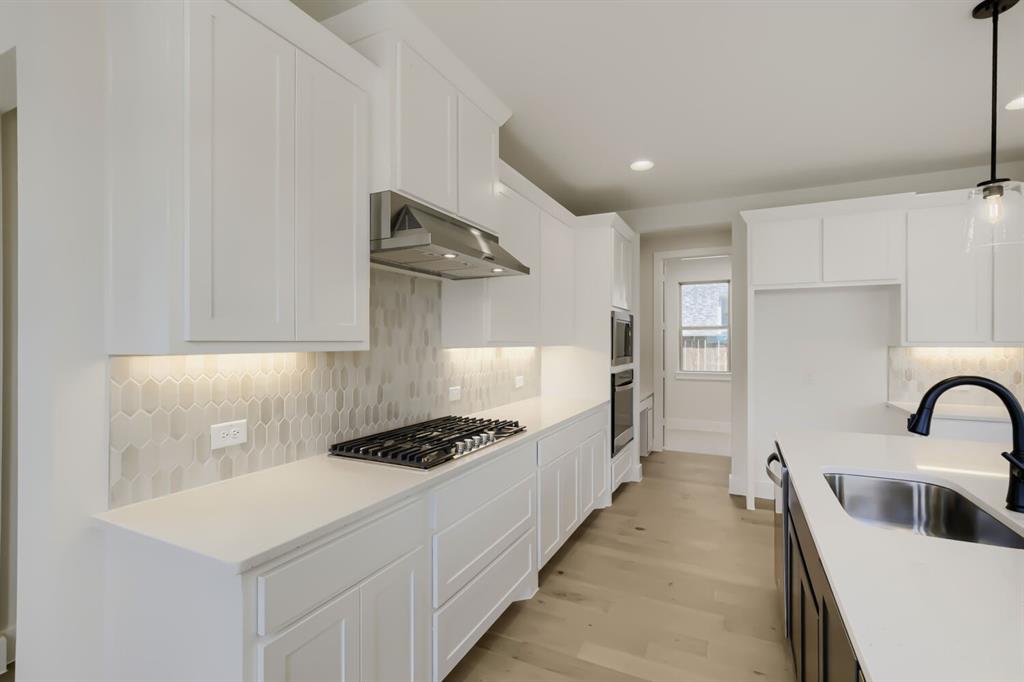 824 Stone Grv Road Lavon, TX 75166 - Photo 8 of 26 Modern kitchen featuring white shaker cabinetry and light-toned countertops
