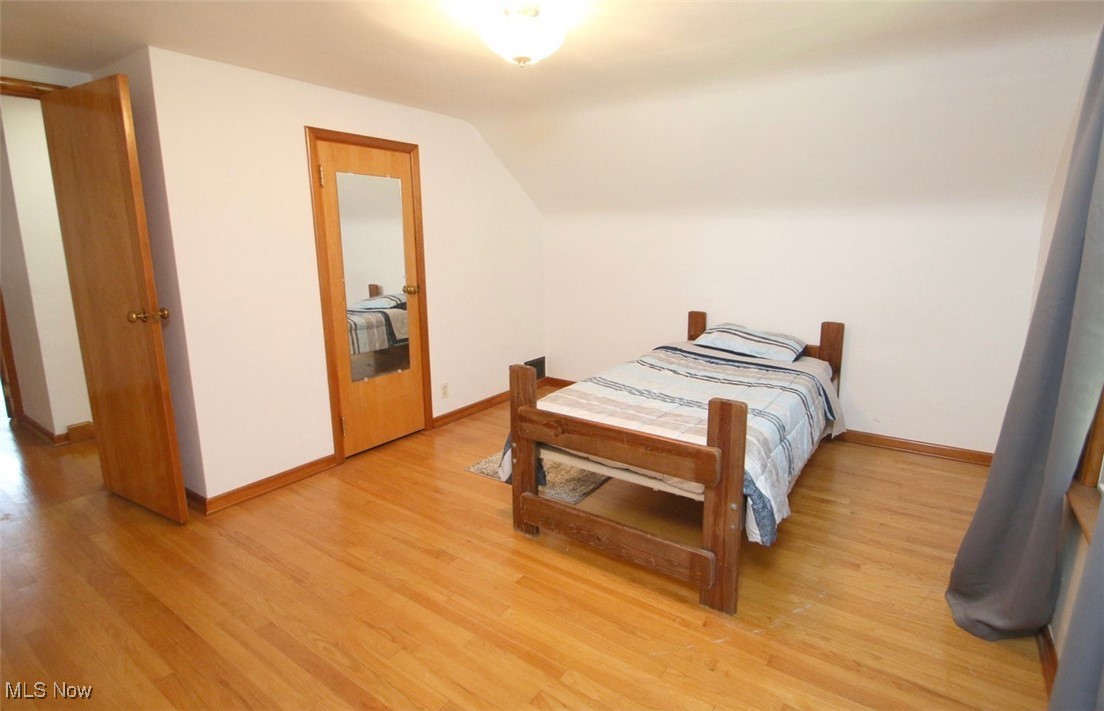 2802 South Ridge Road East Kingsville, OH 44048 - Photo 22 of 42 Bedroom featuring lofted ceiling and light wood-style floors