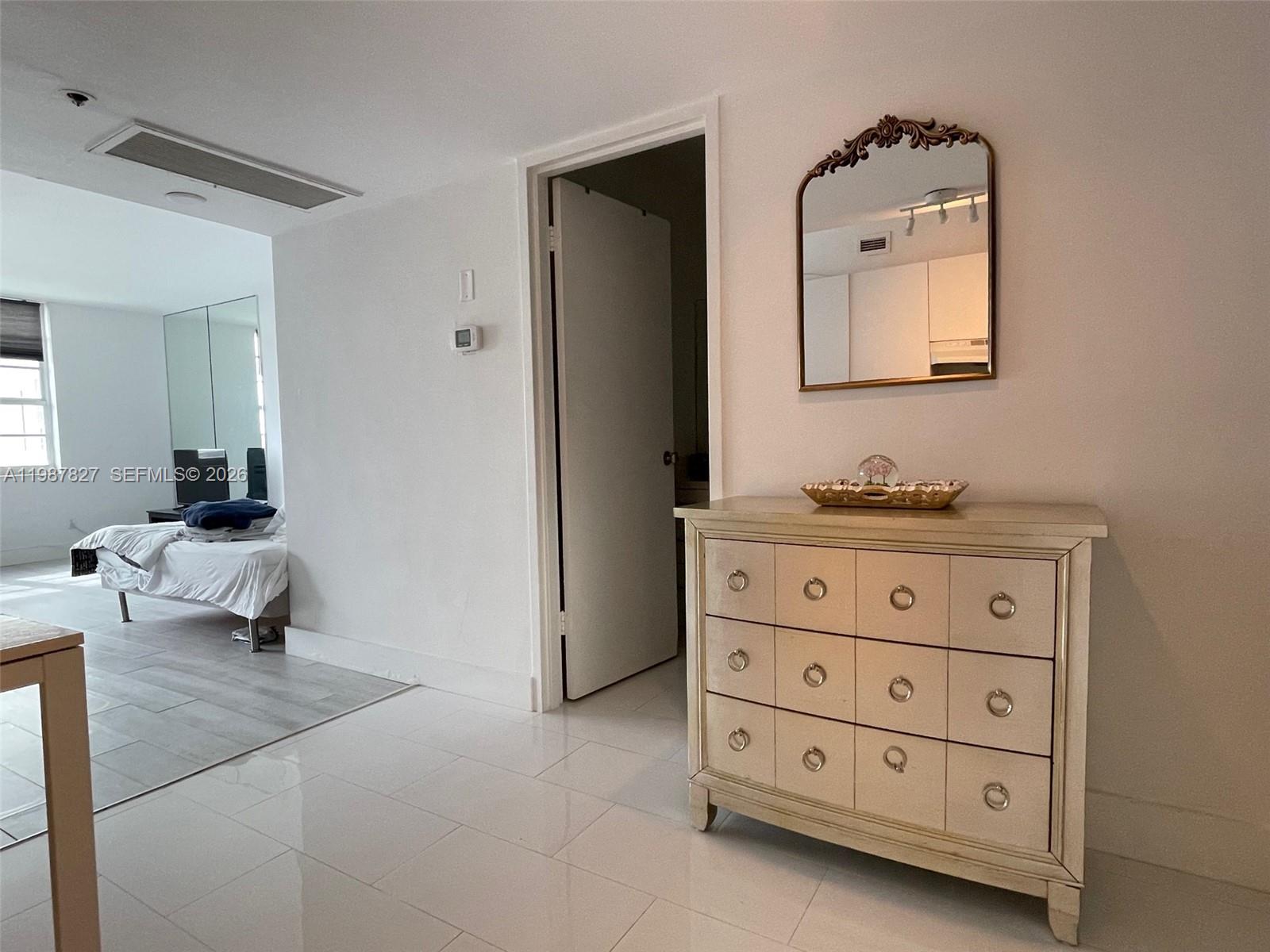 100 Lincoln Road, Unit 1024 Miami Beach, FL 33139 - Photo 11 of 15 a bedroom with a bed and a dresser