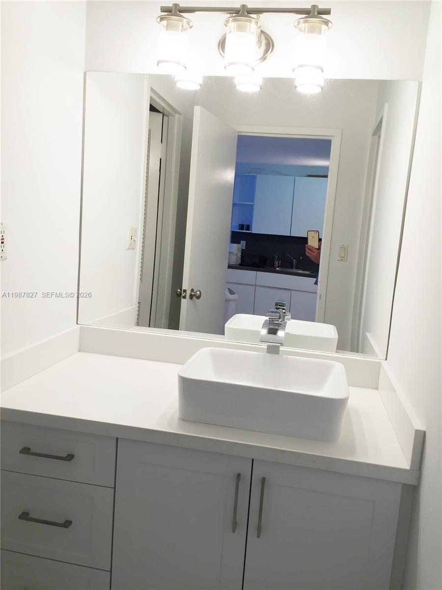 100 Lincoln Road, Unit 1024 Miami Beach, FL 33139 - Photo 13 of 15 a bathroom with a sink and a mirror