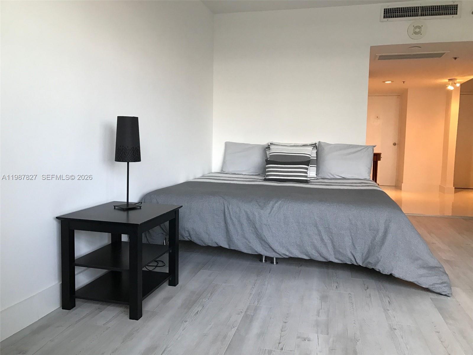 100 Lincoln Road, Unit 1024 Miami Beach, FL 33139 - Photo 6 of 15 a bedroom with a bed and a flat screen tv