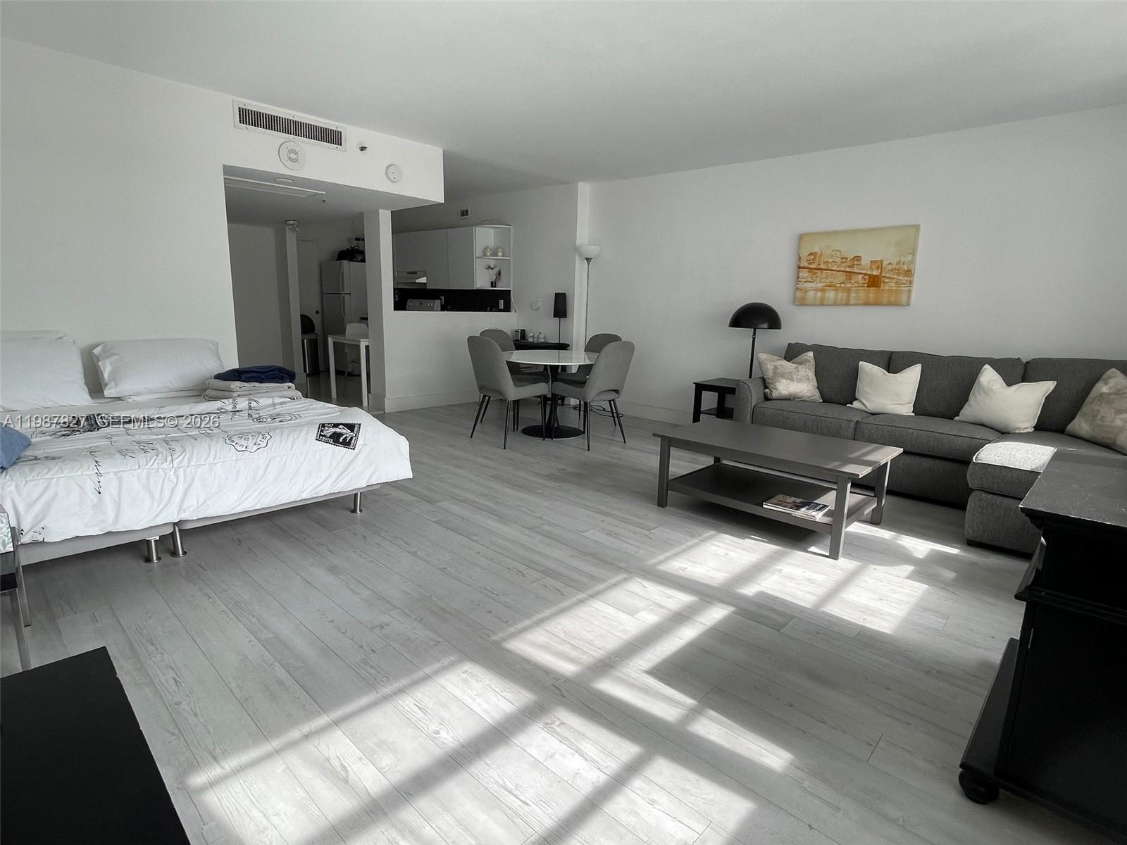 100 Lincoln Road, Unit 1024 Miami Beach, FL 33139 - Photo 7 of 15 a living room with furniture and a wooden floor
