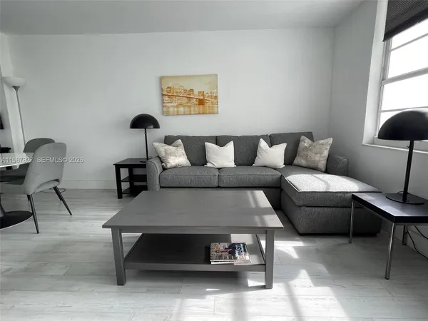 a living room with furniture and a lamp