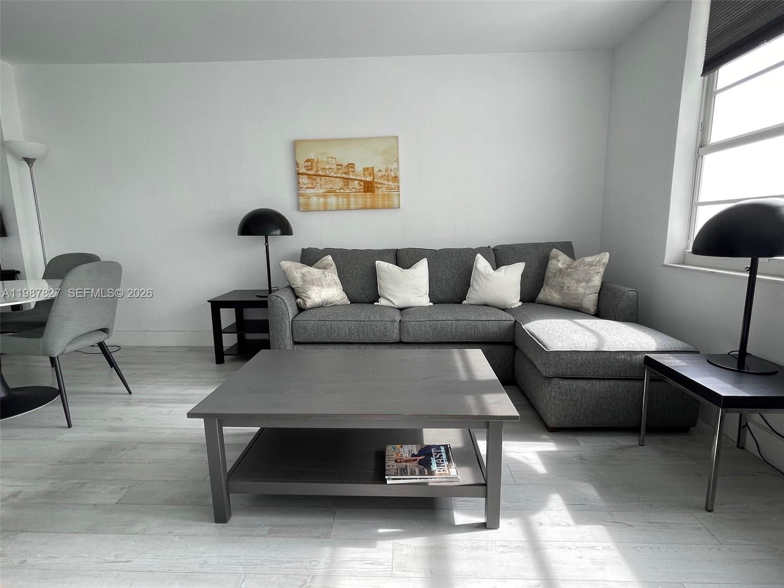100 Lincoln Road, Unit 1024 Miami Beach, FL 33139 - Photo 8 of 15 a living room with furniture and a lamp