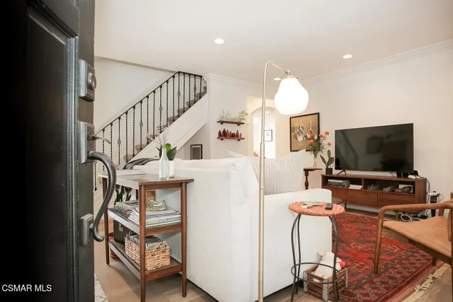 a view of a livingroom with furniture and a flat screen tv