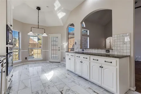 a spacious bathroom with a granite countertop sink a mirror and a shower