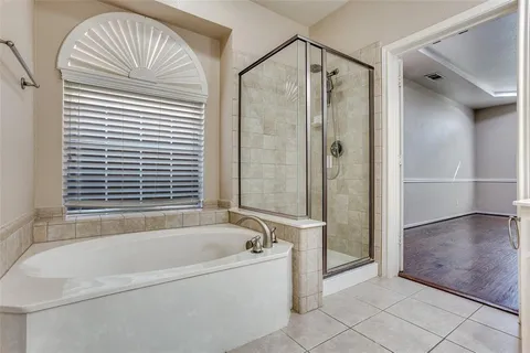 a bathroom with a bathtub and a shower