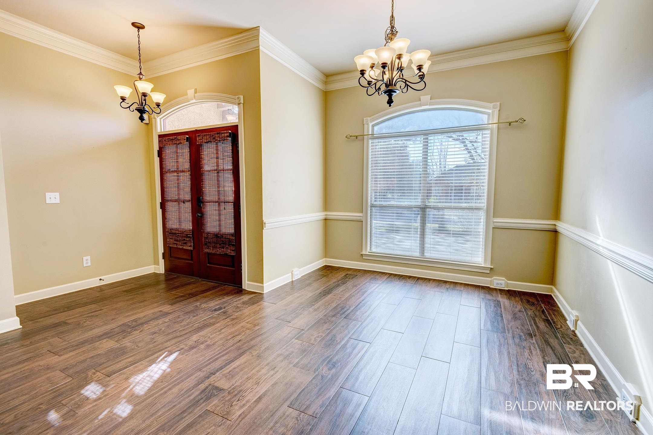 9421 Collier Loop Daphne, AL 36526 - Photo 10 of 31 Unfurnished dining area featuring a chandelier, ornamental molding, and dark wood-style floors