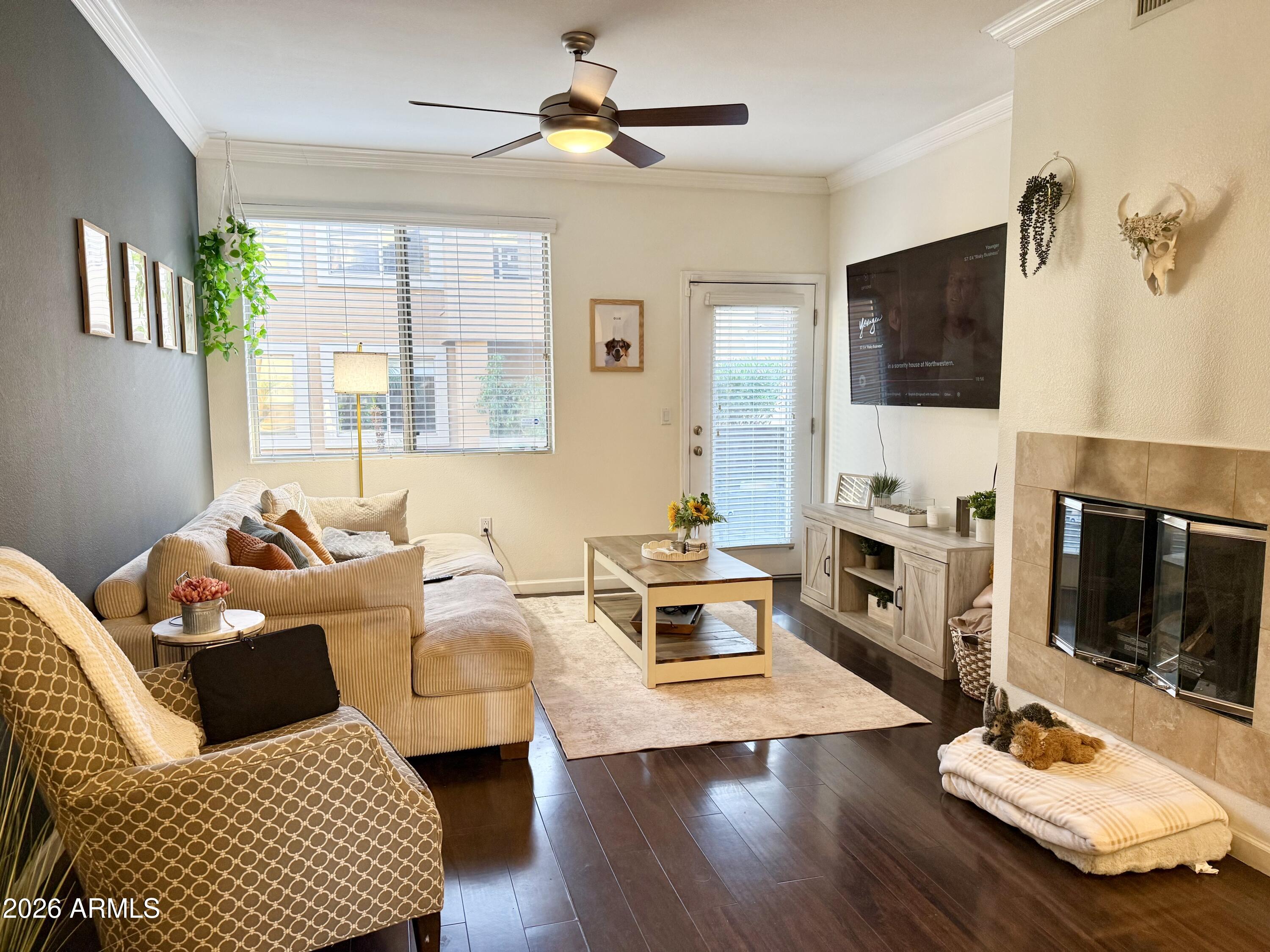 a living room with furniture fireplace and flat screen tv
