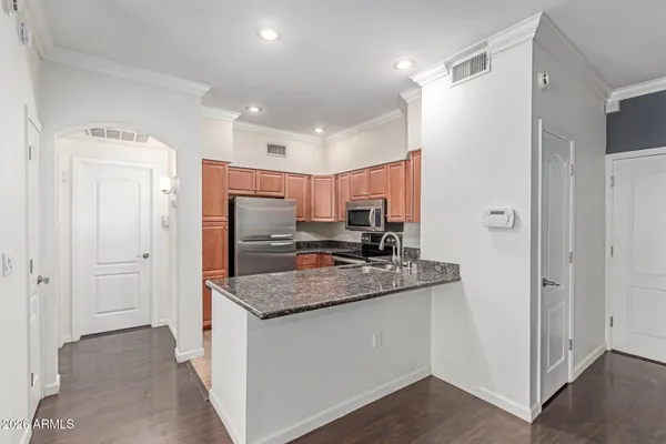 a kitchen with granite countertop a sink and a stove