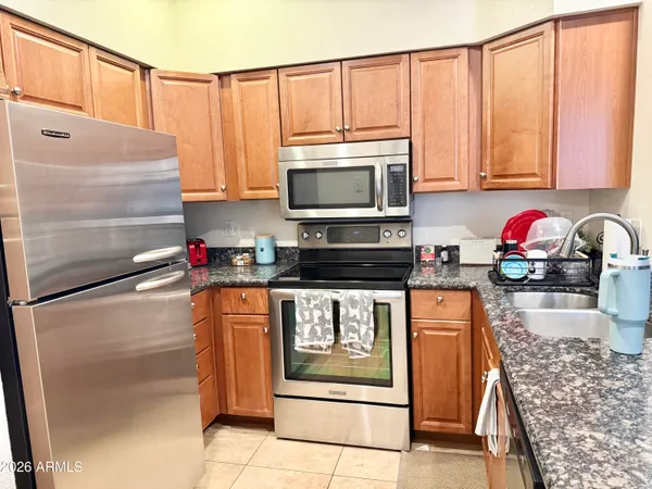 a kitchen with stainless steel appliances granite countertop a sink stove and microwave