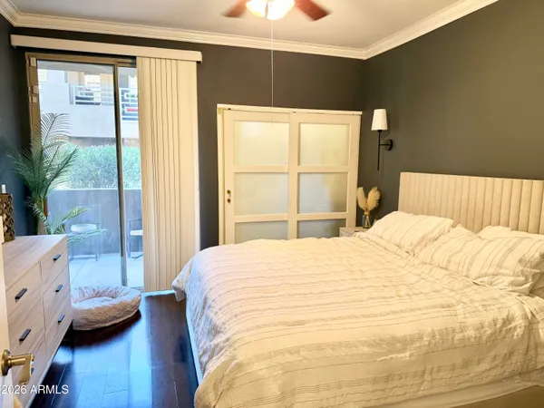 a large bed sitting in a bedroom next to a window