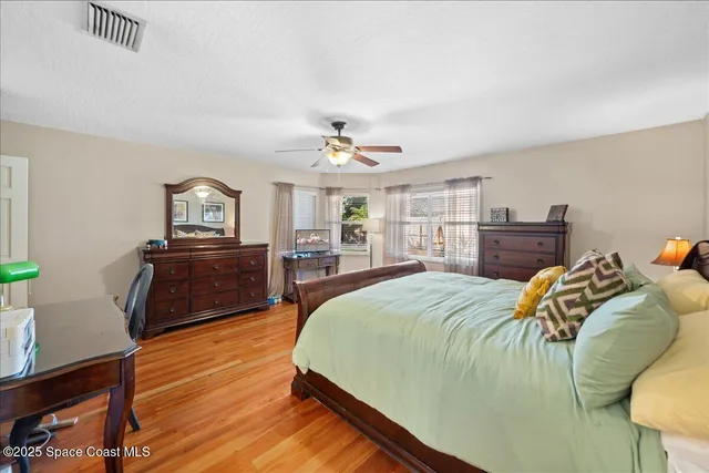 a en suite bathroom with a double vanity sink a mirror and a toilet