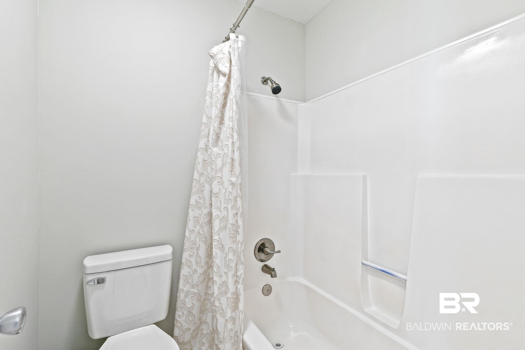 110 5th Street, Unit C103 Daphne, AL 36526 - Photo 14 of 46 Bathroom with toilet and shower / bath combination with curtain
