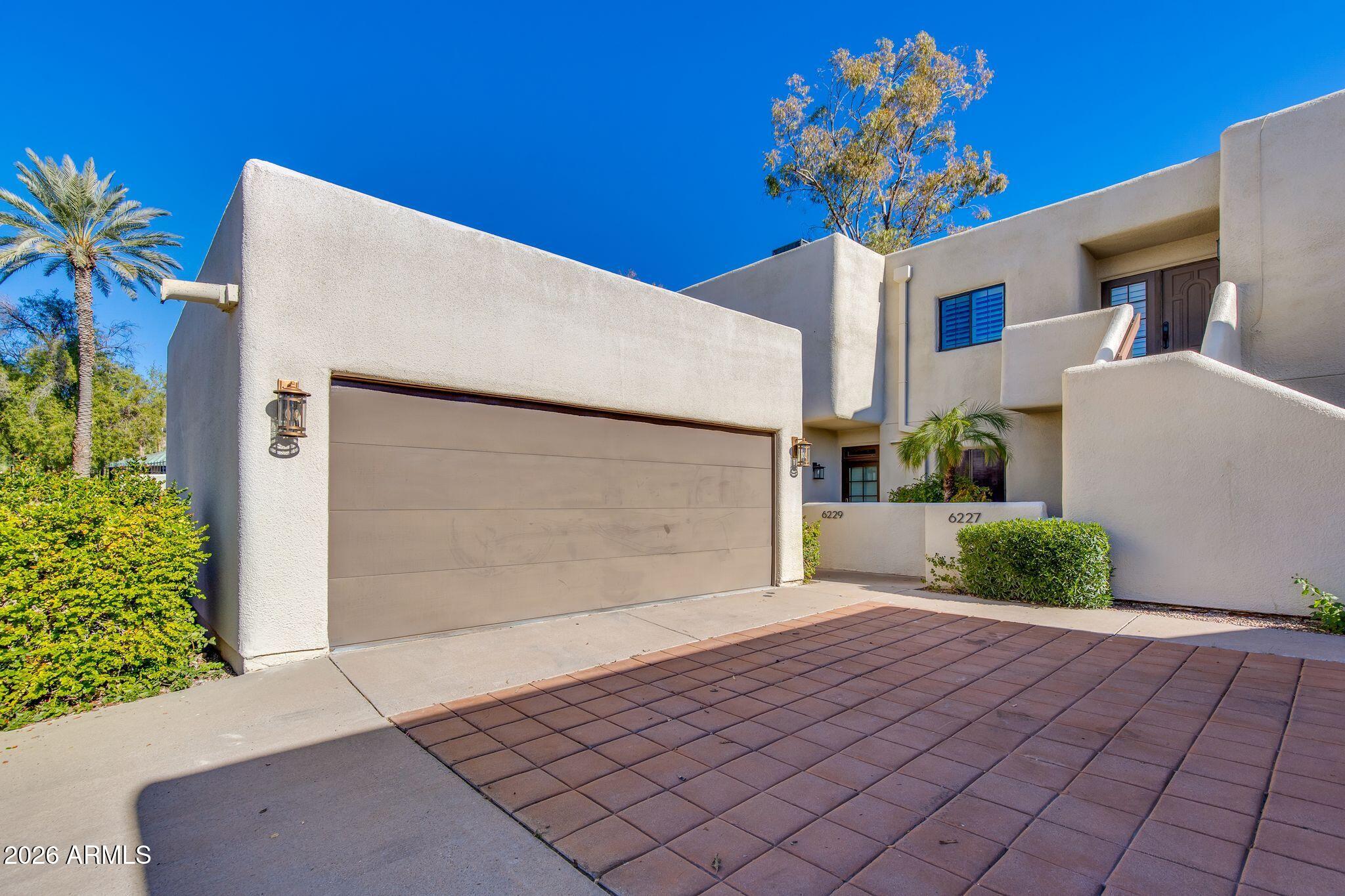 6227 North 30th Way Phoenix, AZ 85016 - Photo 14 of 16 a front view of a house with a yard and garage