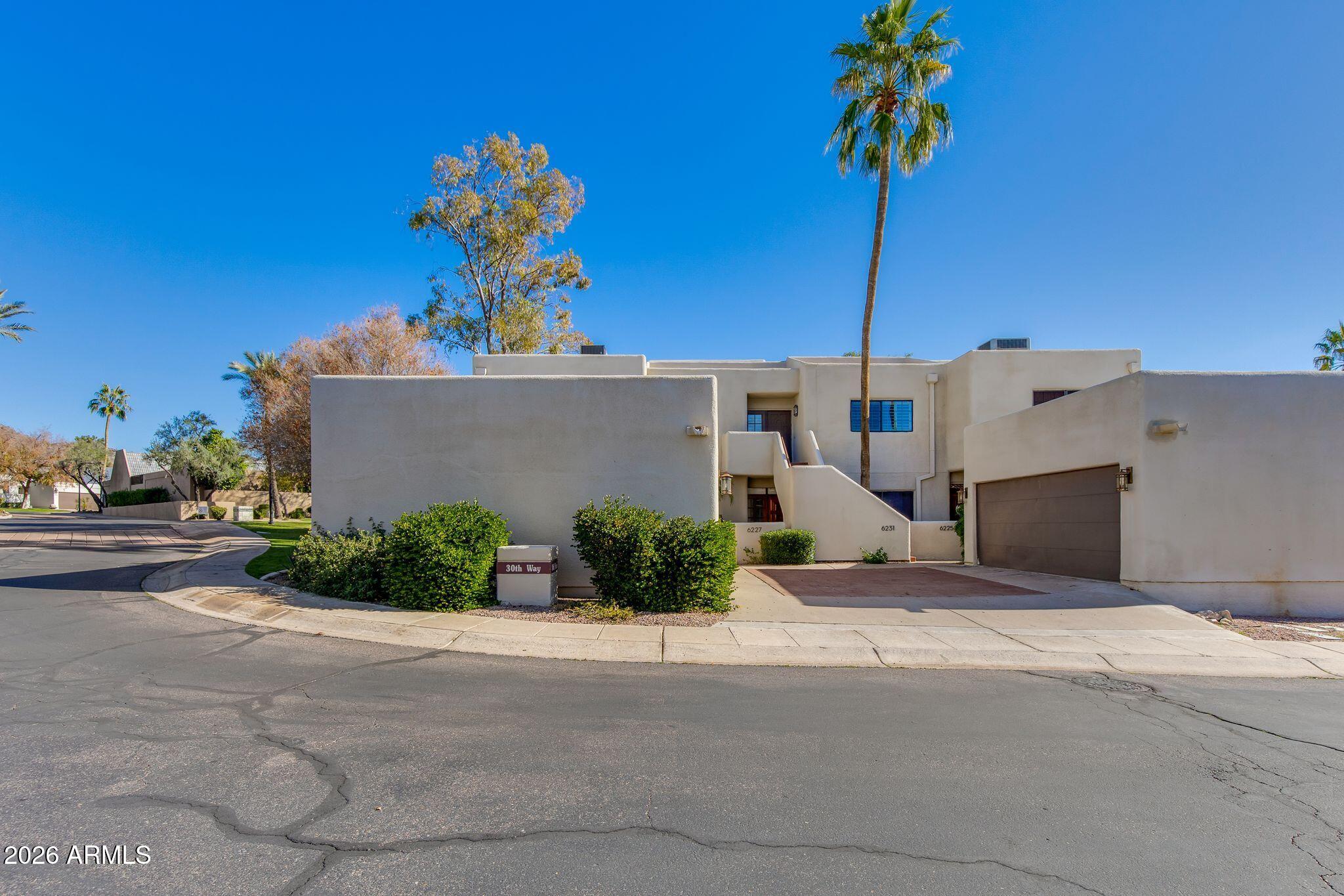 6227 North 30th Way Phoenix, AZ 85016 - Photo 15 of 16 a front view of a house with a yard and garage