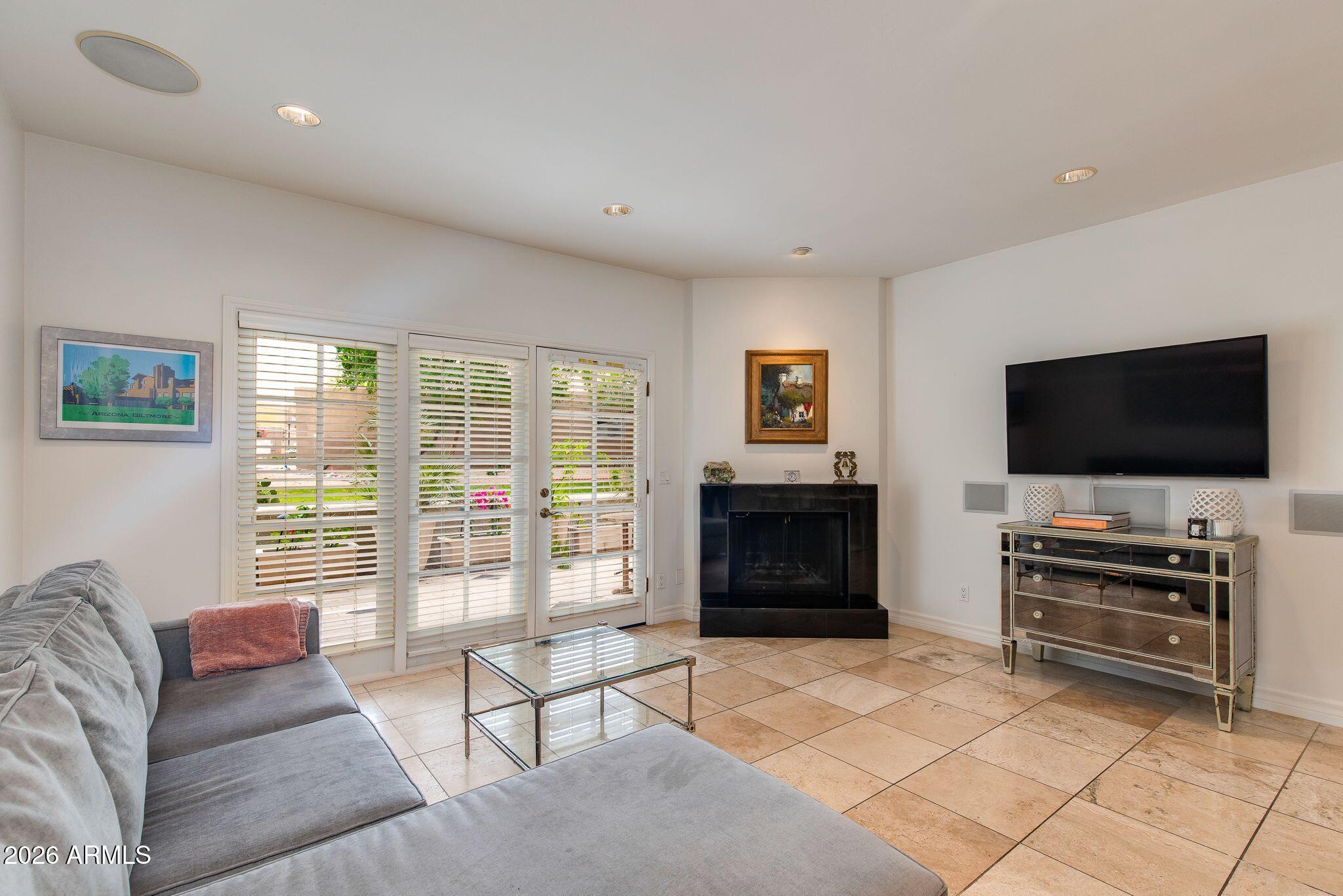 6227 North 30th Way Phoenix, AZ 85016 - Photo 2 of 16 a living room with furniture and a flat screen tv