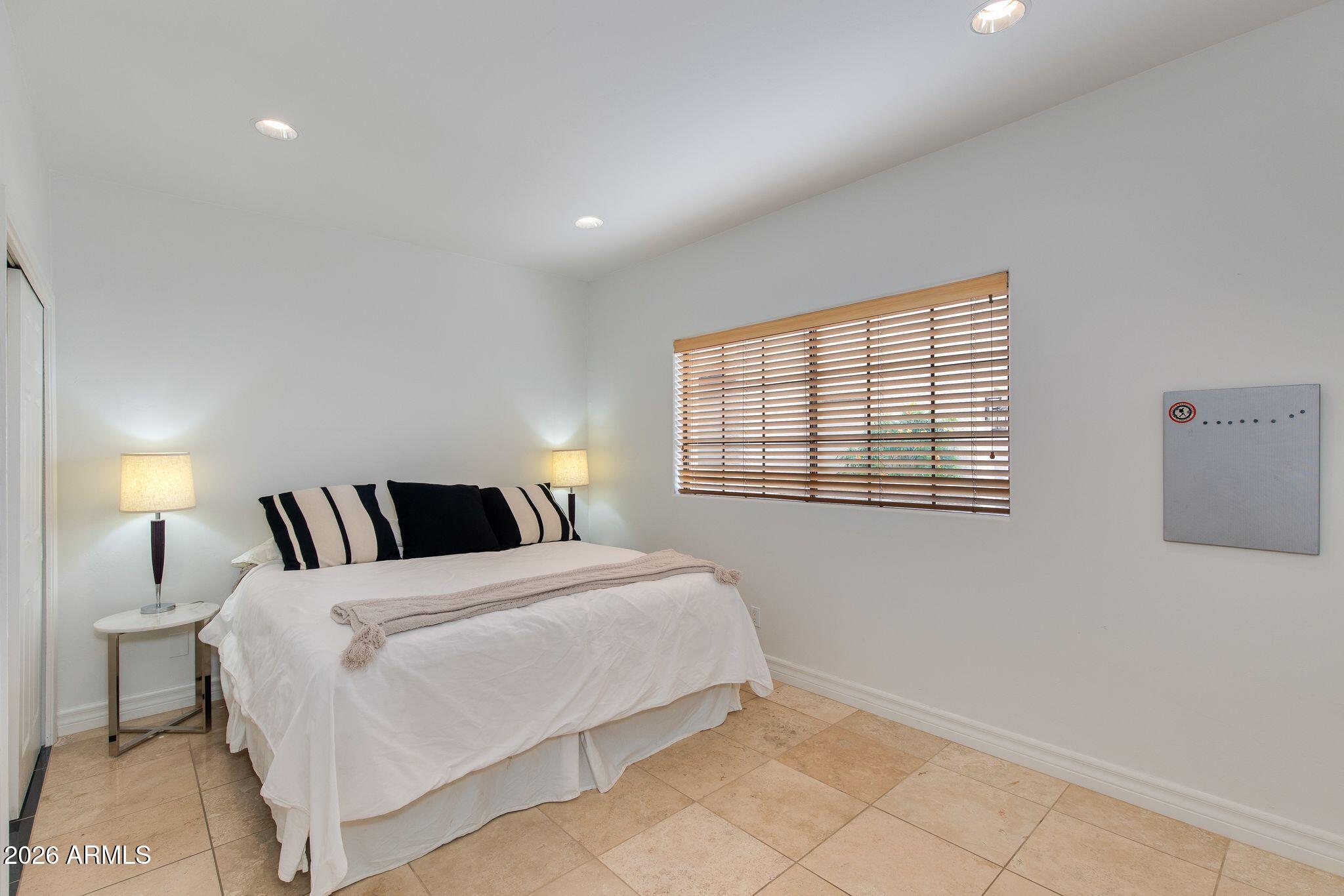 6227 North 30th Way Phoenix, AZ 85016 - Photo 8 of 16 a bedroom with a bed and a window