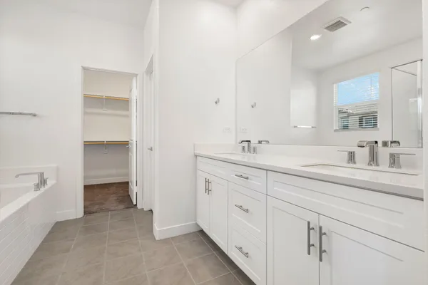 a spacious bathroom with a double vanity sink mirror and