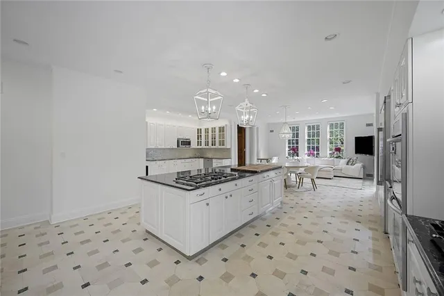 a kitchen with stainless steel appliances a stove a sink a refrigerator and cabinets