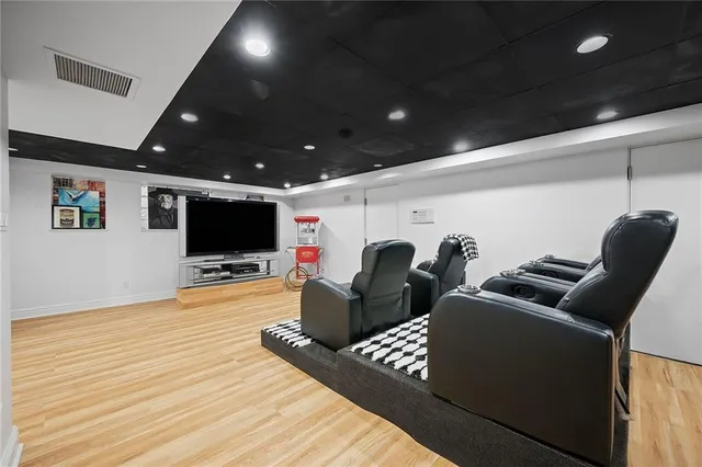 an aerial view of a house with outdoor space and trees all around