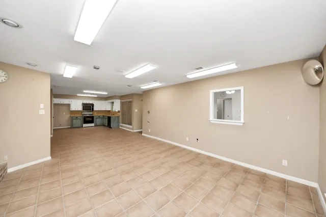 a view of a livingroom with furniture and a window