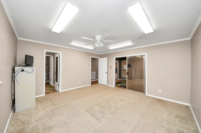 an empty room with windows and closet