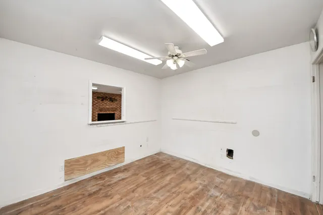 a view of a backyard with a slide trees and wooden fence