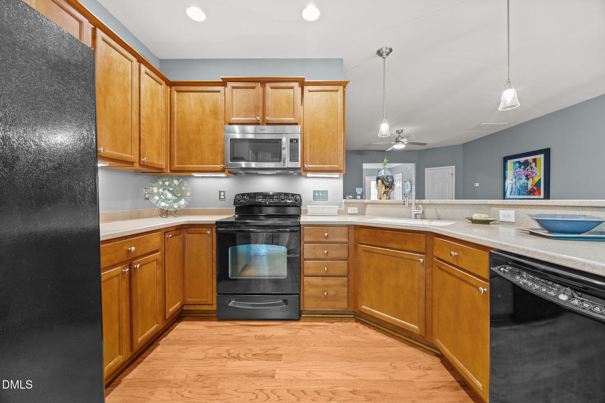 7022 Racine Way Raleigh, NC 27690 - Photo 11 of 26 a kitchen with stainless steel appliances granite countertop a sink stove and refrigerator