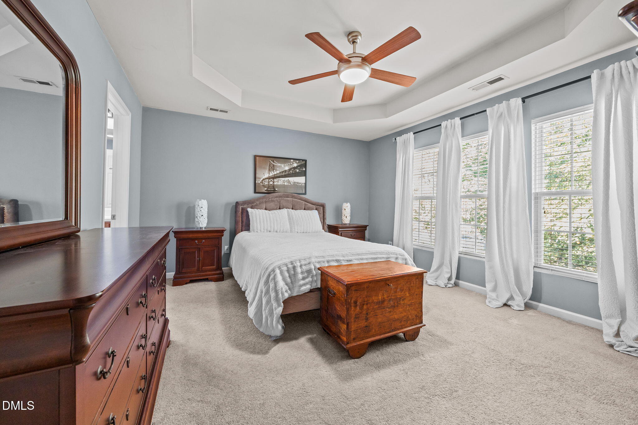 7022 Racine Way Raleigh, NC 27690 - Photo 13 of 26 a bedroom with a large bed and a chandelier