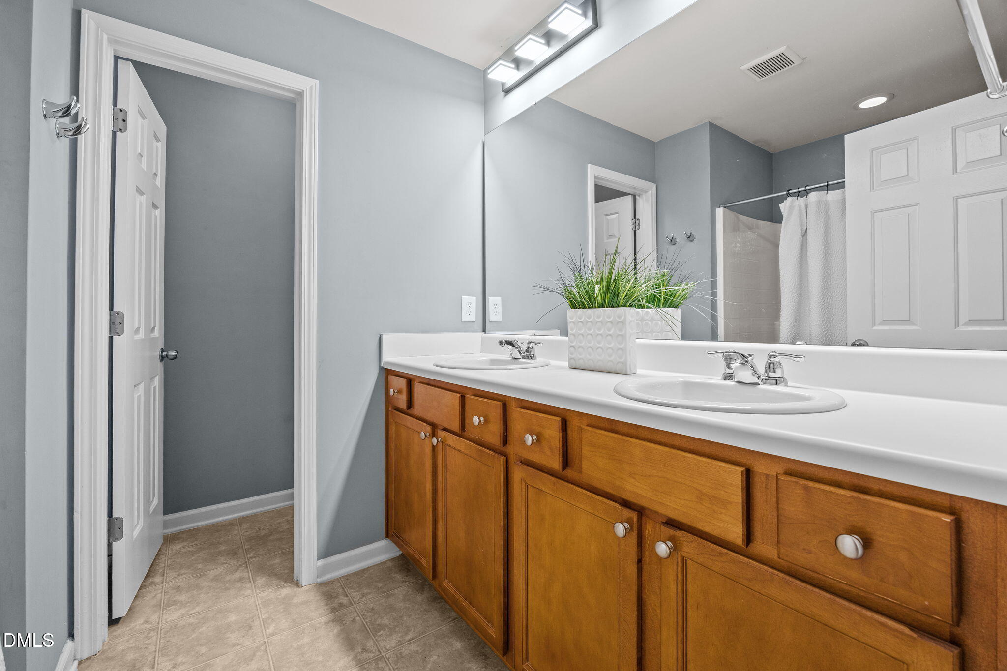 7022 Racine Way Raleigh, NC 27690 - Photo 16 of 26 a bathroom with a sink and a mirror