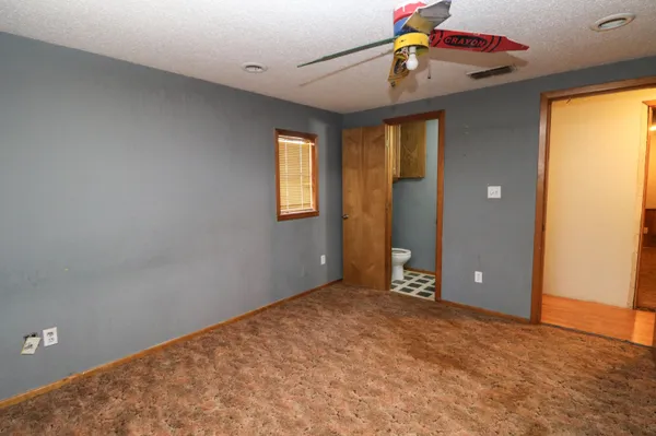 a view of a livingroom with a ceiling fan and window