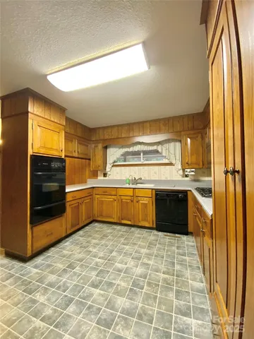 a kitchen with a sink stove and cabinets