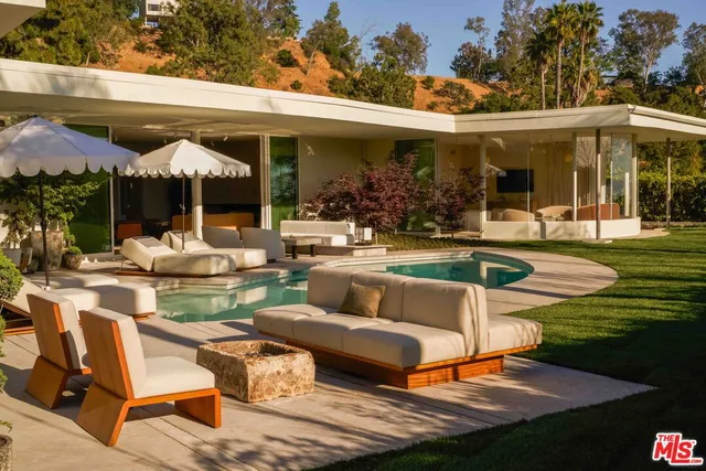 a view of a house with backyard porch and sitting area