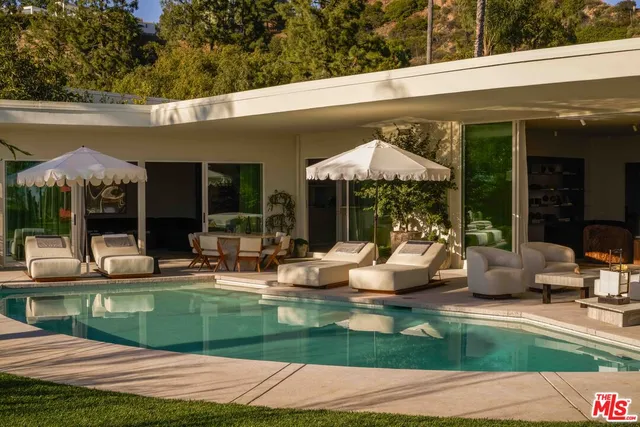 a swimming pool view with a outdoor seating