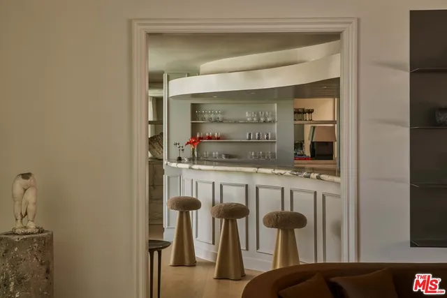 a kitchen with stainless steel appliances kitchen island granite countertop a refrigerator and cabinets