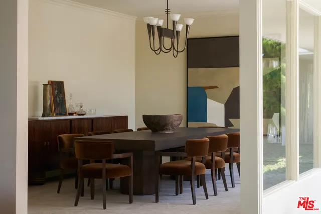 a view of a dining room with furniture and chandelier