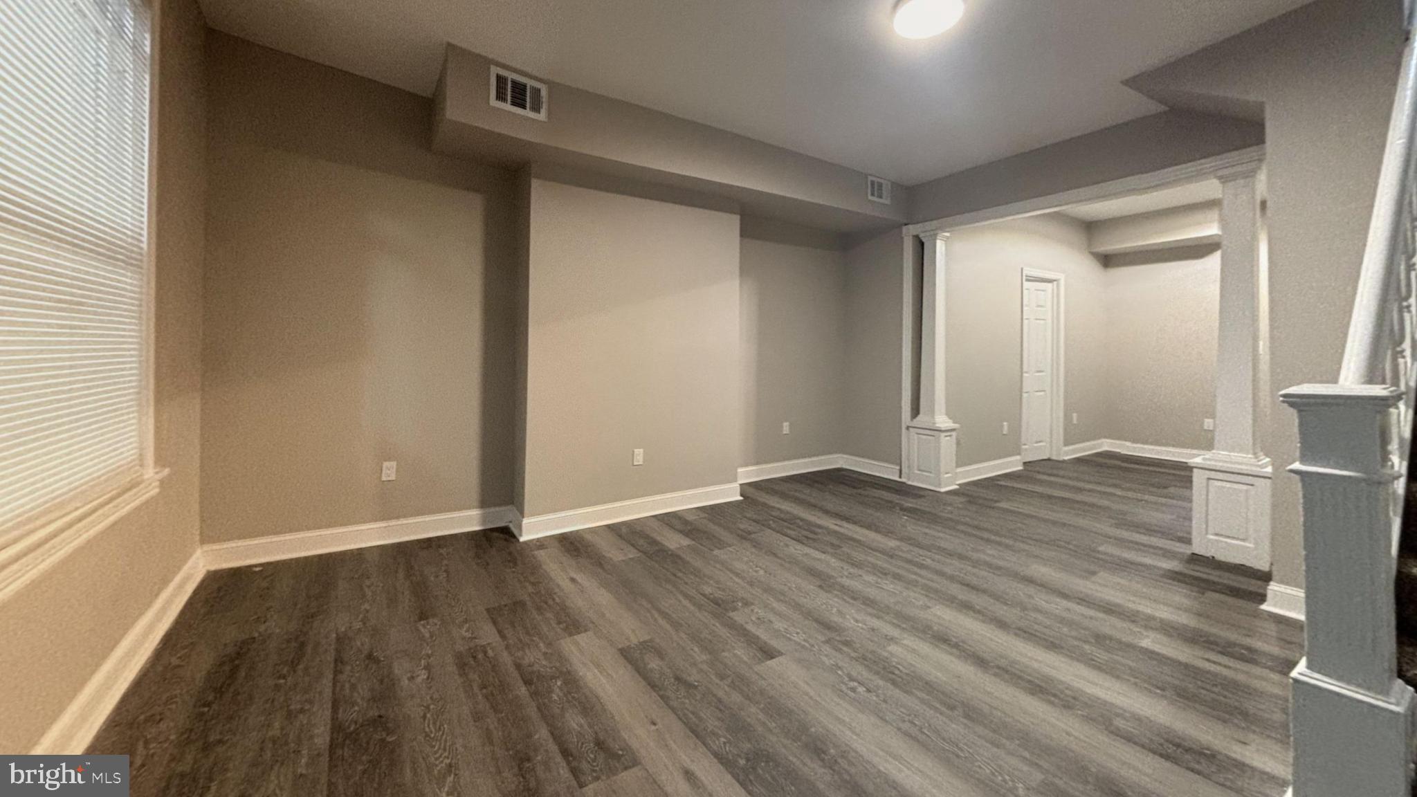 2527 South Felton Street Philadelphia, PA 19142 - Photo 2 of 11 a view of an empty room with wooden floor and a window