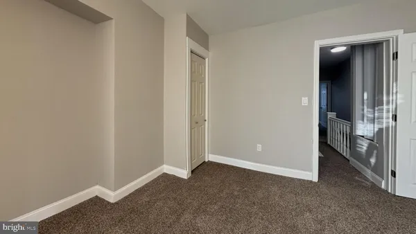 an empty room with an entrance and door