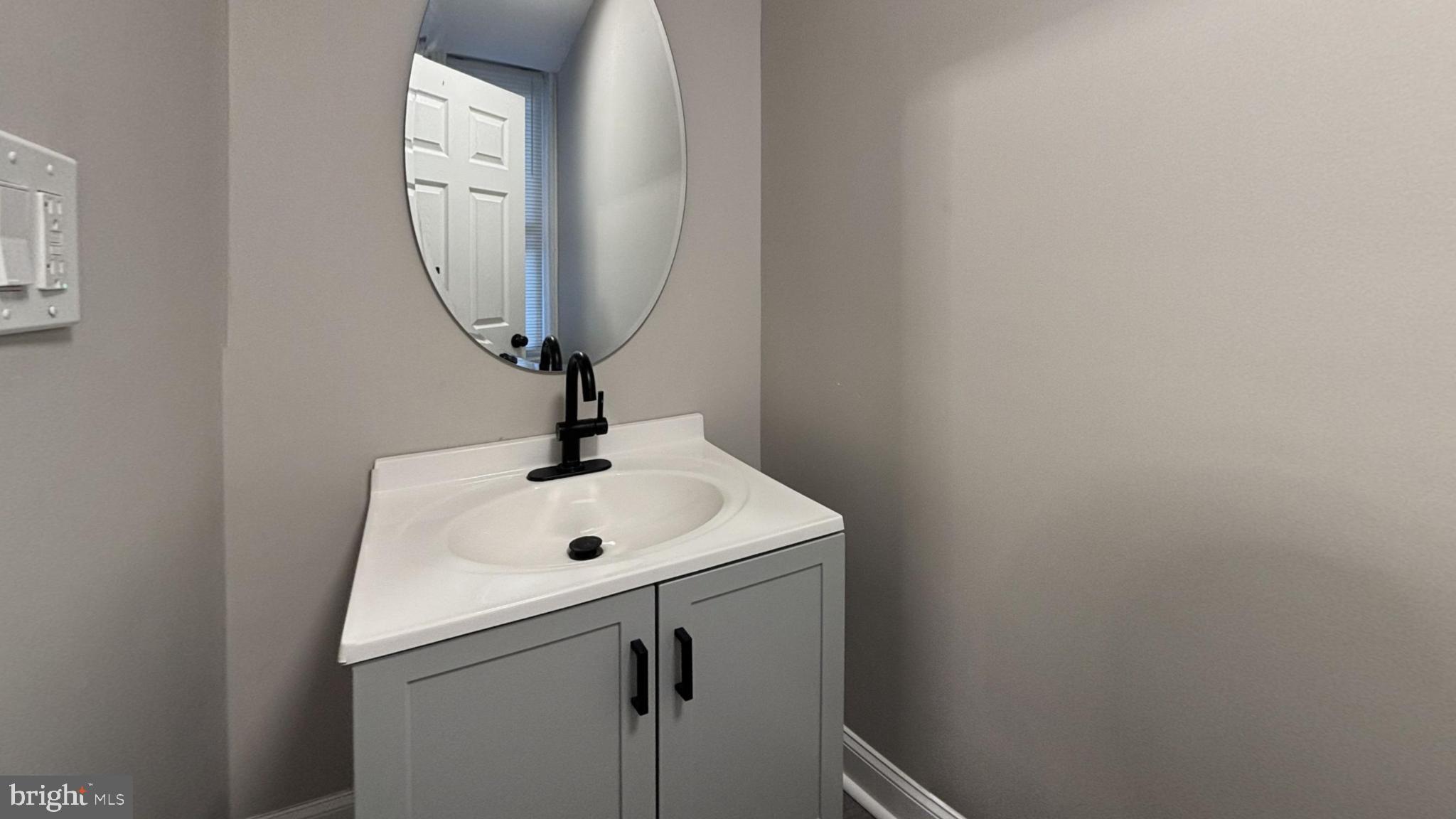 2527 South Felton Street Philadelphia, PA 19142 - Photo 10 of 11 a sink with a mirror