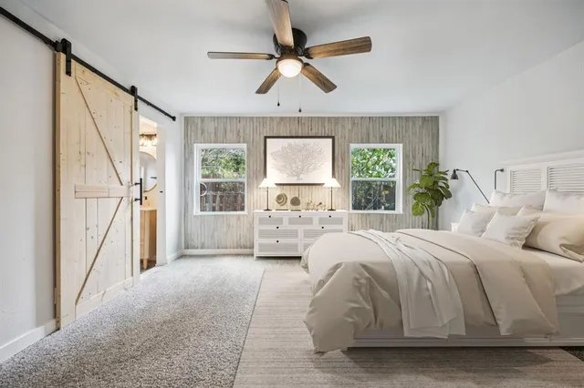 a bedroom with a large bed and a large window